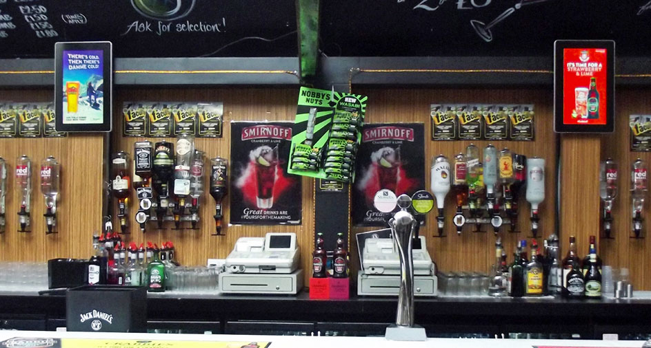 Wall mounted digital screen behind bar Wall mounted digital screen behind bar