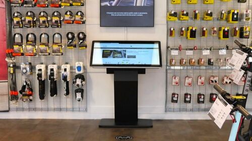 Angled freestanding touch-screen kiosk table in electrical wholesaler