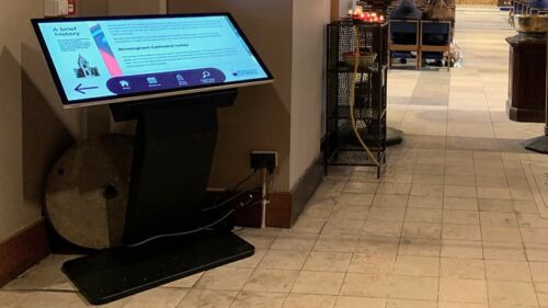 Freestanding touchscreen angled table kiosk in a church