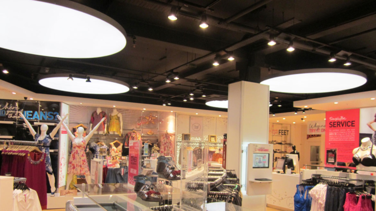 Illuminated ceiling discs for ambient lighting at Simply Be stores