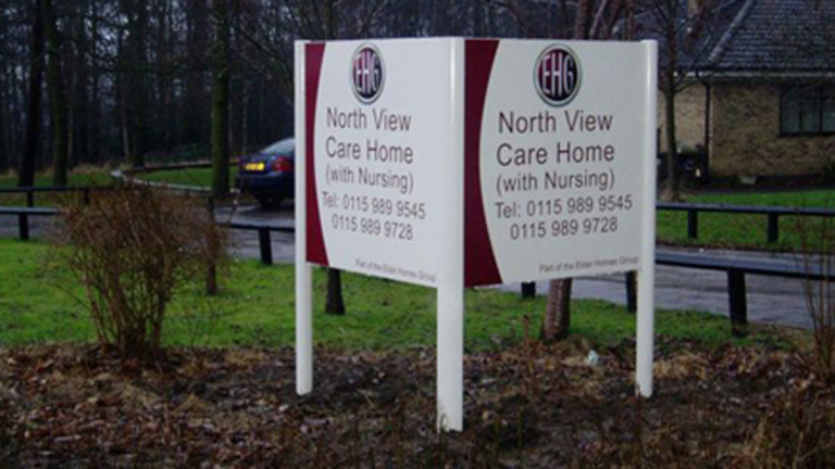 Post and panel sign outside care home
