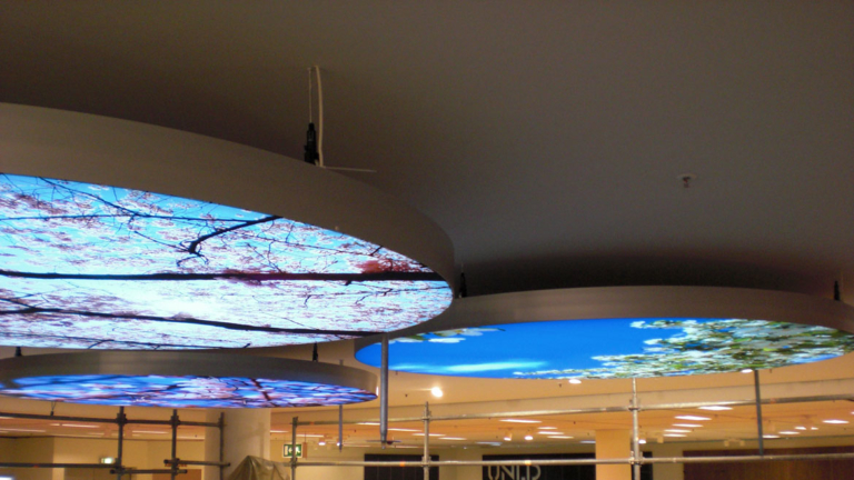 Tension fabric face LED illuminated ceiling discs